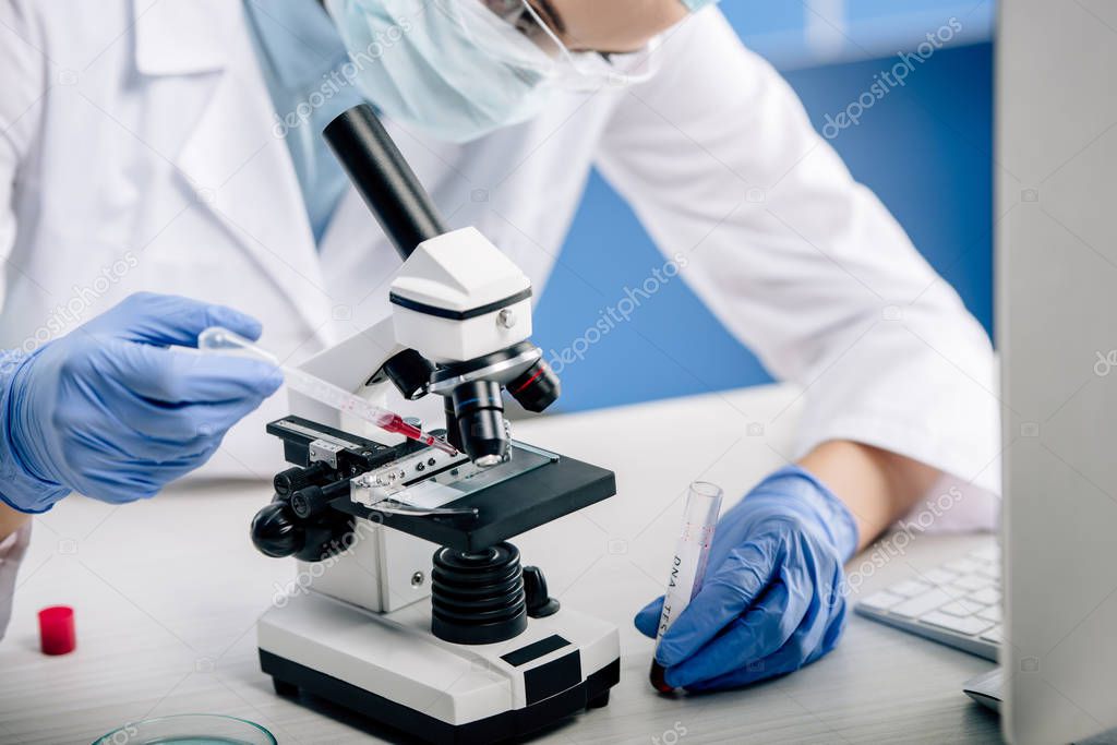 cropped view of genetic consultant doing dna test in lab 