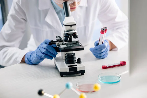 Cropped View Genetic Consultant Using Microscope Holding Test Tubes — Stock Photo, Image