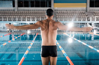 back view of swimmer standing with outstretched hands  clipart