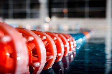 selective focus of wet buoys in swimming pool  clipart