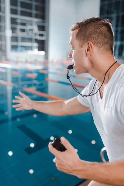 Selective Focus Trainer Whistle Mouth Gesturing While Holding Timer — Stock Photo, Image