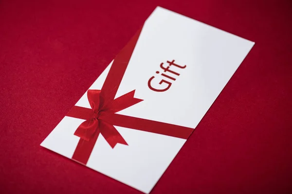 White Gift Card Red Bow Red Surface — ストック写真