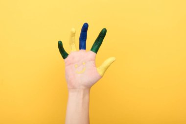 cropped view of woman with colorful fingers showing palm isolated on yellow clipart