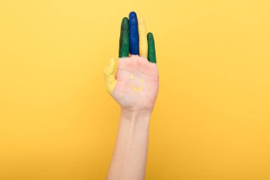 cropped view of woman showing colorful fingers isolated on yellow clipart
