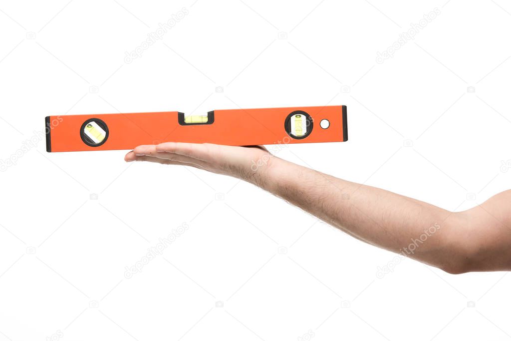 cropped view of woman holding spirit level isolated on white