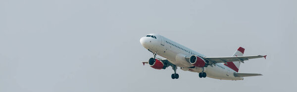 Panoramic shot of airplane with cloudy sky at background
