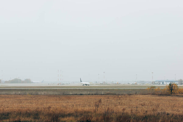 Airplanes on airport highway in grassy field