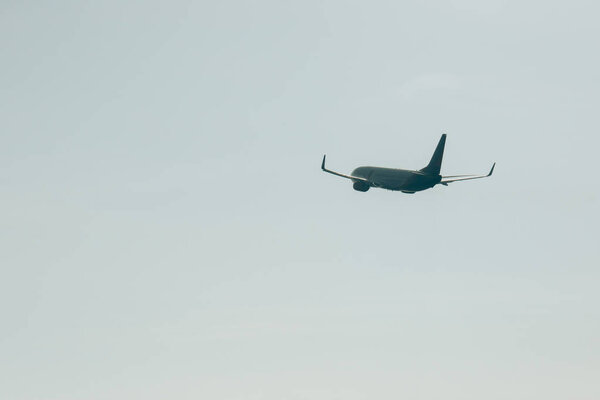 Flight departure of airplane in cloudy sky