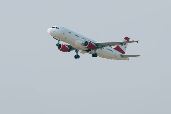 Flight departure of commercial plane in cloudy sky 