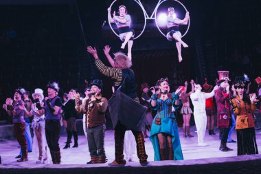 KYIV, UKRAINE - NOVEMBER 1, 2019: Selective focus of performers applauding at circus arena clipart