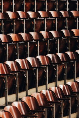Selective focus of rows of empty wooden seats in circus  clipart
