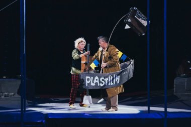 KYIV, UKRAINE - NOVEMBER 1, 2019: Artists performing with boat and suitcase in circus clipart