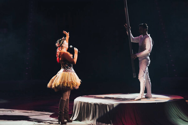 KYIV, UKRAINE - NOVEMBER 1, 2019: Side view of air gymnast and artist at circus stage