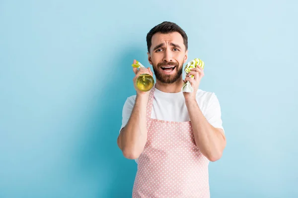 Upset Bearded Man Holding Rag Spray Bottle Cleaning Blue — Stock Photo, Image