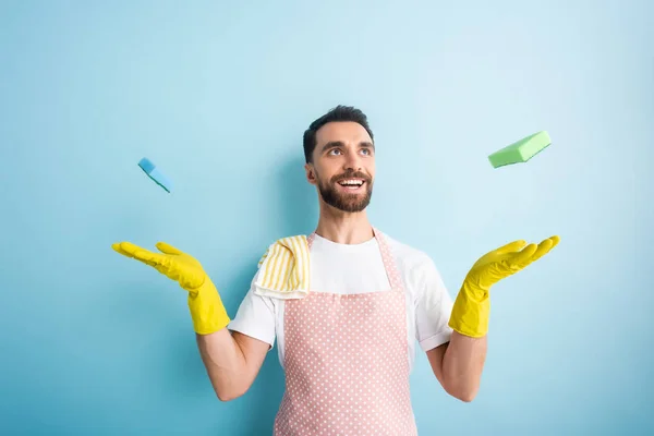 Cheerful Bearded Man Apron Throwing Air Sponges Blue — Stock Photo, Image