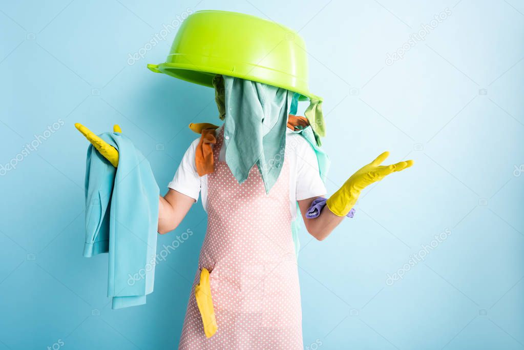 plastic wash bowl and dirty laundry on man in dotted apron