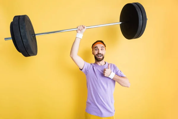 Cheerful Sportsman Holding Barbell Showing Thumb Yellow — 스톡 사진