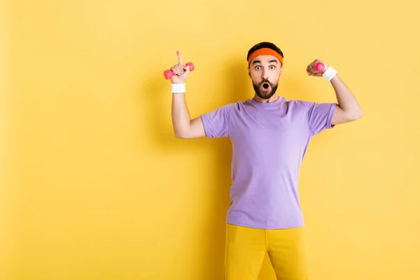 Surprised Bearded Man Pointing Finger While Holding Small Dumbbells Yellow — Stock Photo, Image