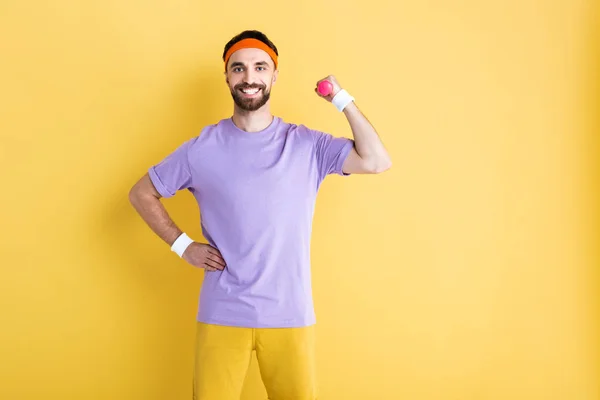 Cheerful Sportsman Holding Dumbbell While Standing Hand Hip Yellow — Stock Photo, Image