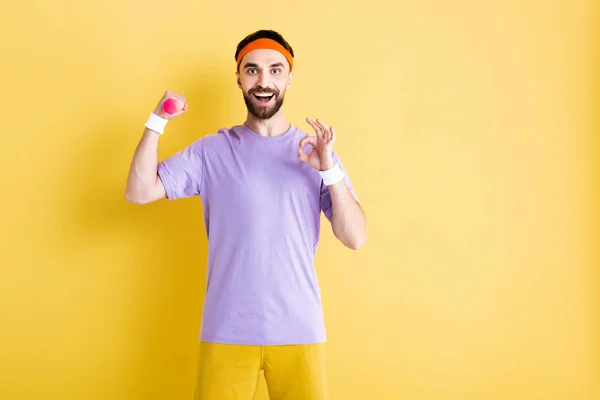 Cheerful Sportsman Holding Small Dumbbell Showing Sign Yellow — Stock Photo, Image
