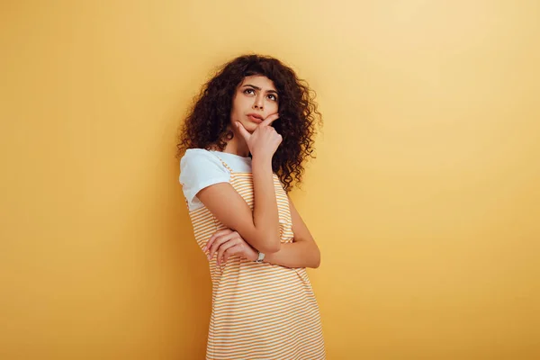 Thoughtful Racial Woman Looking Away While Touching Face Yellow Background — Stock Photo, Image