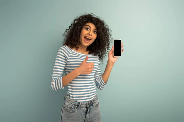 Happy Mixed Race Girl Showing Thumb While Holding Smartphone Blank — Stock Photo, Image