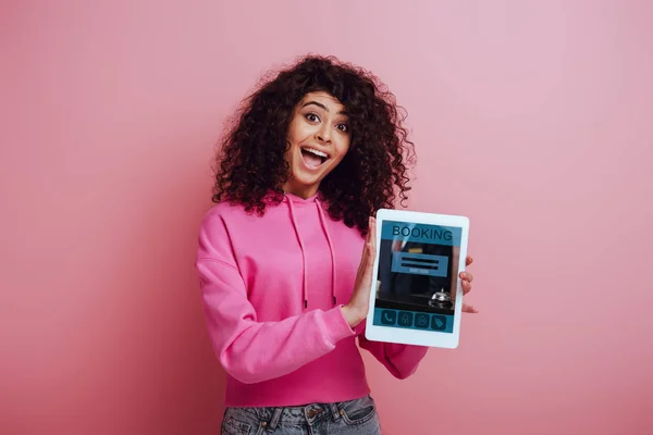 Excited Racial Girl Showing Digital Tablet Booking App Pink Background — ストック写真