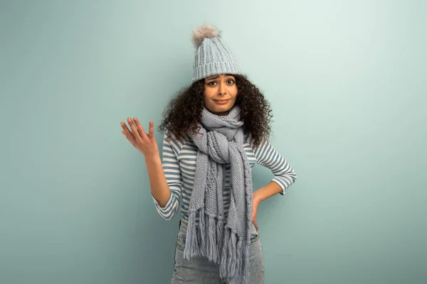 Offended Racial Girl Warm Hat Scarf Looking Camera Grey Background — ストック写真