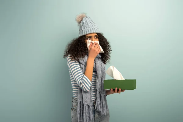 Diseased Racial Girl Warm Hat Scarf Sneezing Napkin Grey Background — 스톡 사진