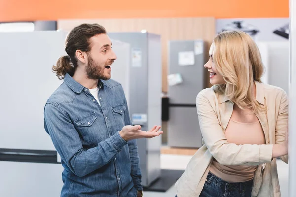 Shocked Boyfriend Looking Smiling Girlfriend Home Appliance Store — Stock Photo, Image