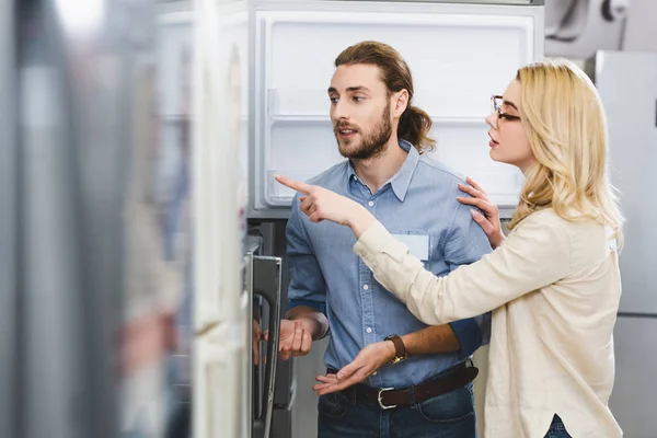 Woman Talking Consultant Pointing Finger Fridge Home Appliance Store — Stock Photo, Image