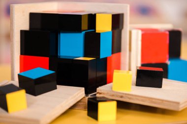 Selective focus of colorful building blocks on table  clipart