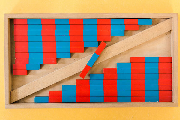Top view of colorful game with wooden blocks on yellow background