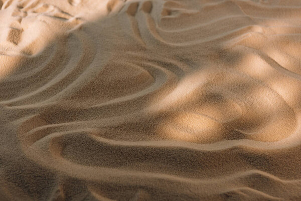 High angle view of textured sand with sunlight