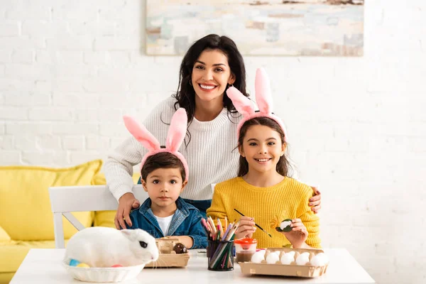 Happy Woman Kids Bunny Ears Smiling Camera While Painting Easter — Stock Photo, Image