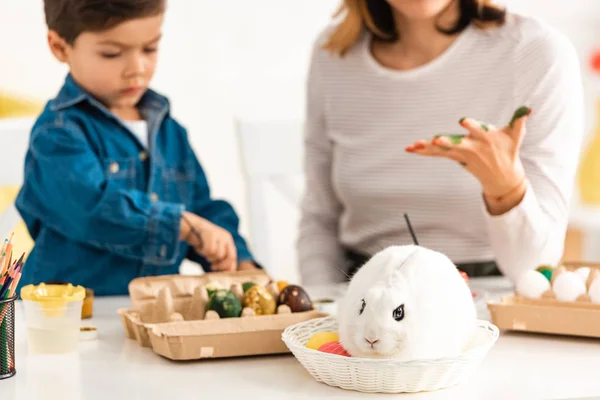Selective Focus Adorable Boy Painting Easter Eggs While Sitting Mother — Stock Photo, Image