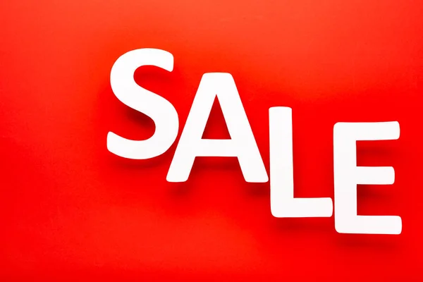 top view of white sale lettering on red background