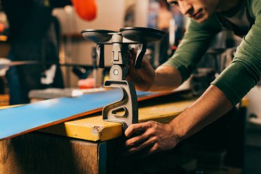 cropped view of worker holding grip vice in repair shop 