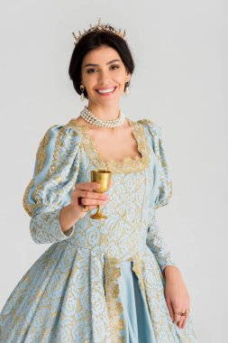 smiling queen with crown holding cup isolated on grey