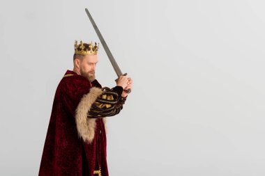 king with crown holding sword and fighting isolated on grey