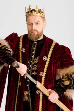 serious king with crown holding sword isolated on grey