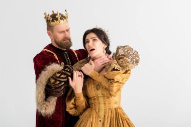 king with crown choking attractive queen isolated on grey