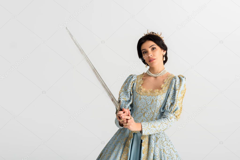 attractive queen with crown holding sword isolated on grey