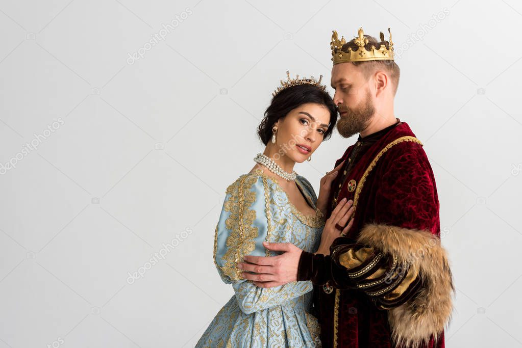 queen and king with crowns hugging isolated on grey 