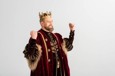 happy king with crown showing yes gesture isolated on grey clipart