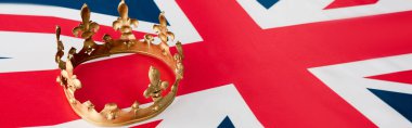 panoramic shot of golden crown on british flag 