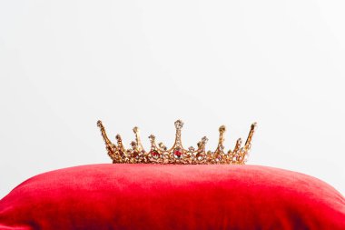 royal crown on red pillow isolated on white with copy space 