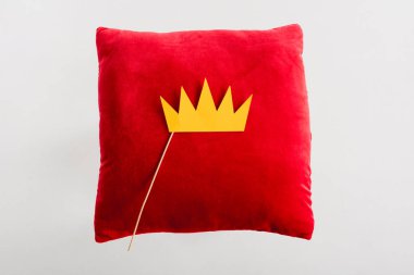 top view of paper crown on red pillow isolated on white 