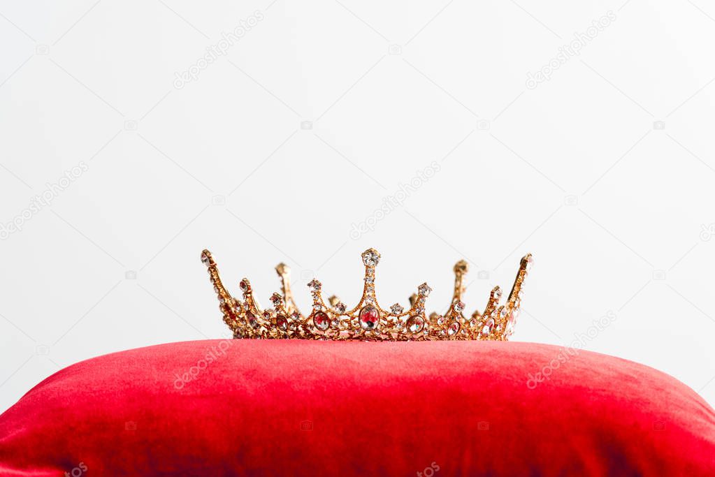 royal crown on red pillow isolated on white with copy space 