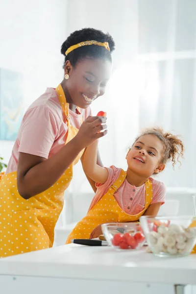 Selective Focus Happy African American Mother Holding Cherry Tomato Kid — 스톡 사진